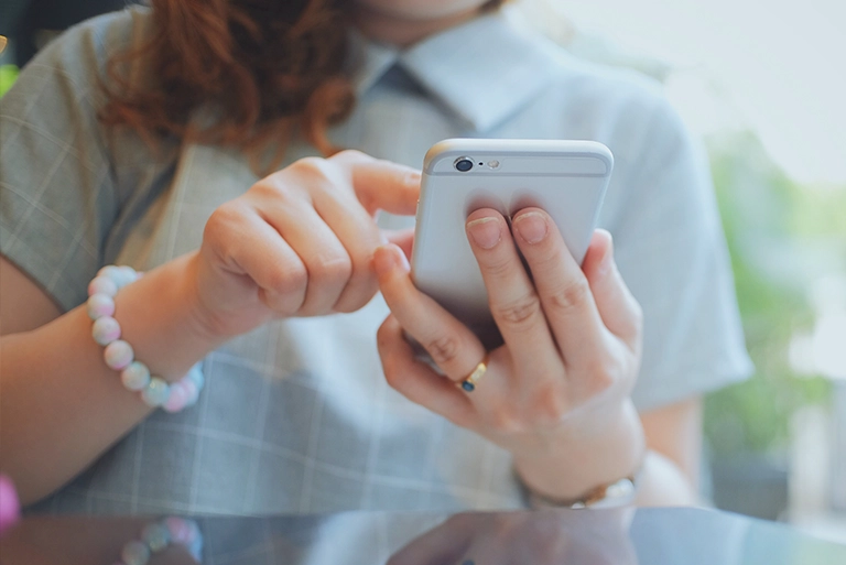 A woman's hands holding a smartphone