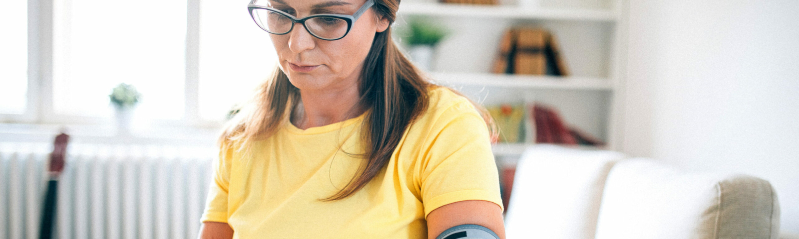Woman with blood pressure monitor