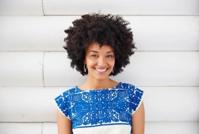 A woman in a colorful shirt smiling at the camera