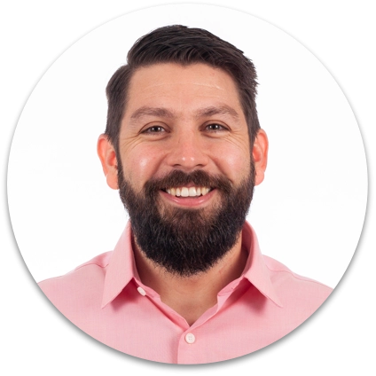 Headshot of man wearing pink shirt