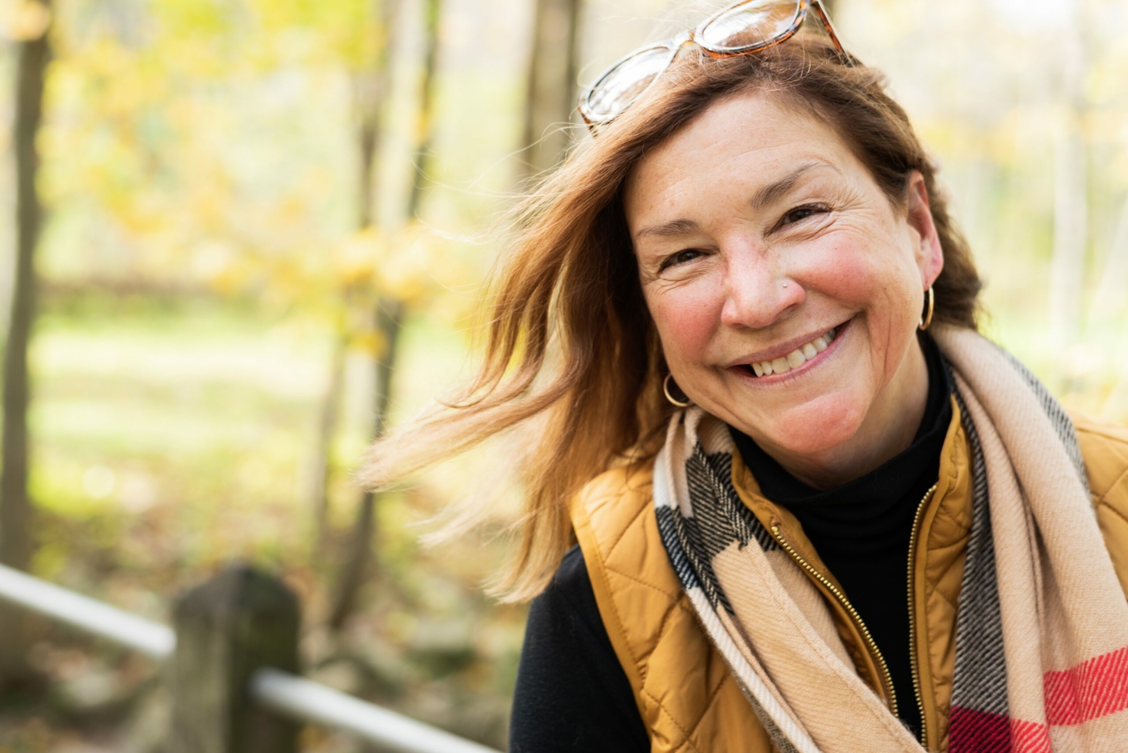 happy middle aged woman hiking in the fall