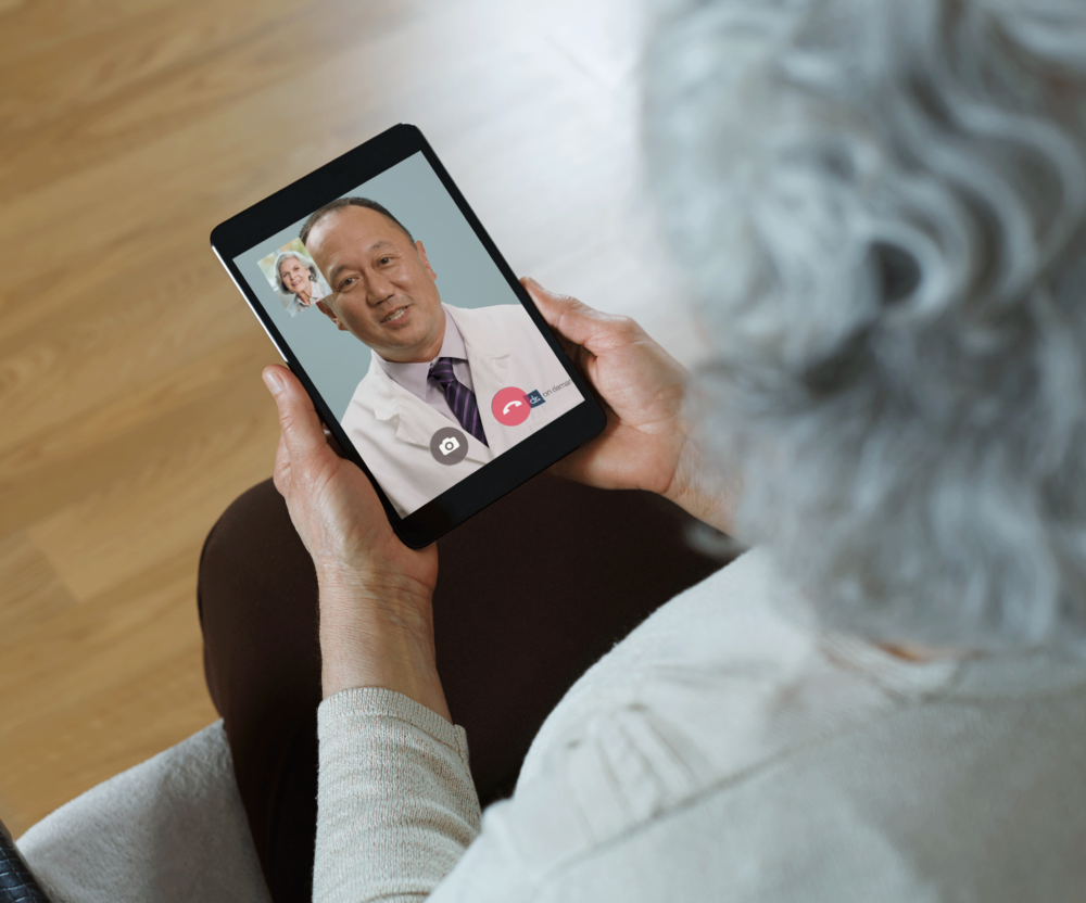 older woman speaking with doctor on her tablet