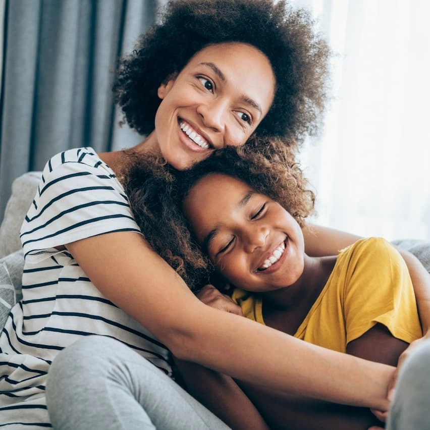 Mom and daughter happy and hugging