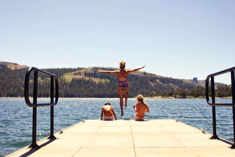 kids jumping off swimming dock