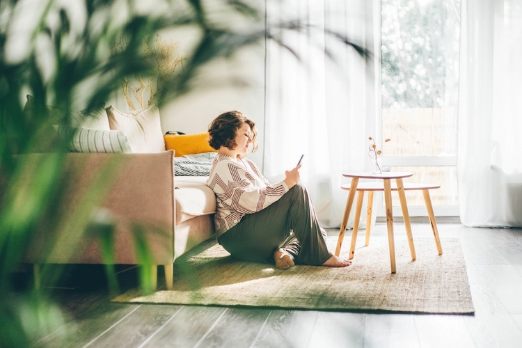 woman sitting on floor on phone