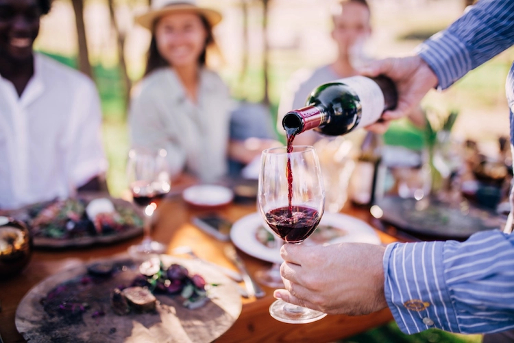 pouring wine at social gathering