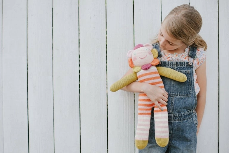 little girl holding a doll