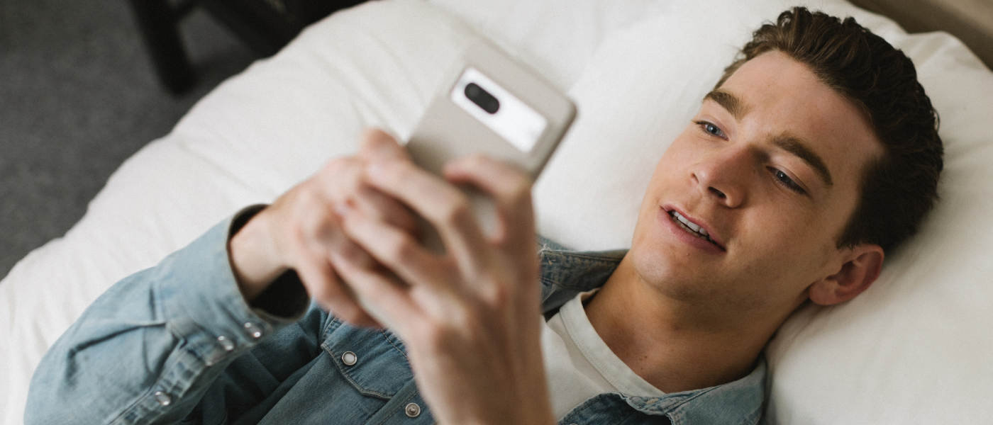 Man in bed with smartphone