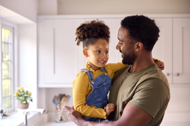 military dad holding daughter