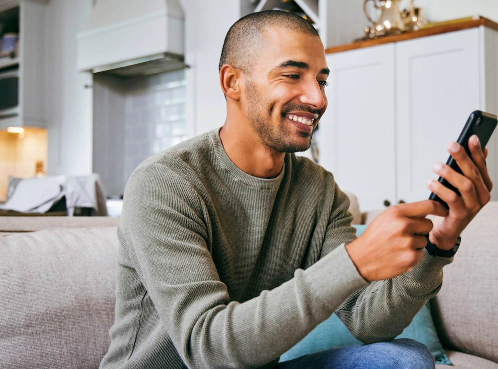 Young man using his phone for virtual care.