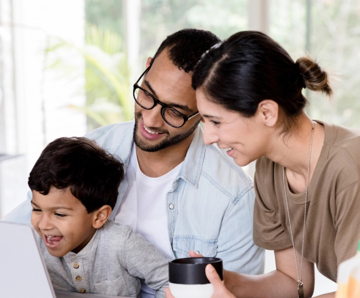 Military family laughing together looking at computer