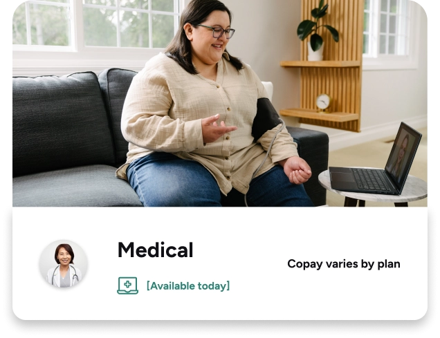 woman taking blood pressure talking to a virtual doctor through her computer.