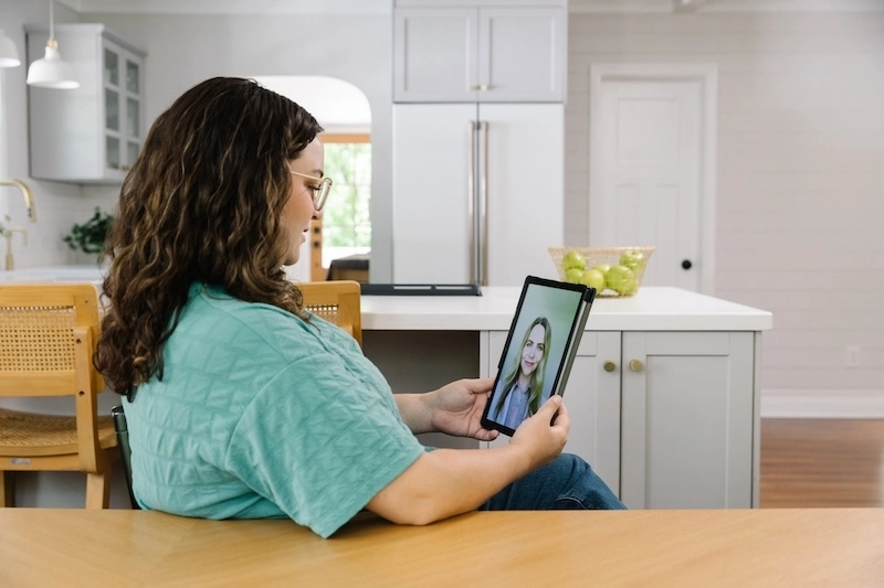woman using her ipad for a Doctor On Demand visit.