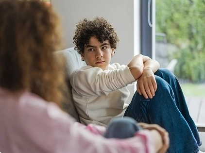 upset teen looking at parent
