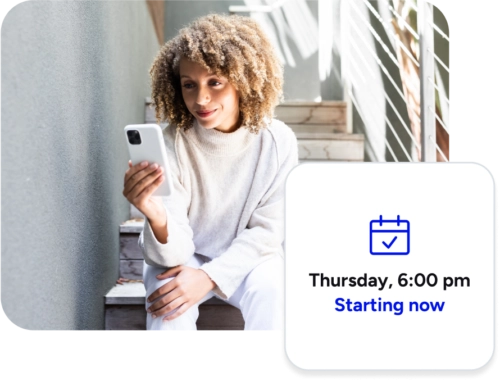 woman sitting on stairs looking at phone