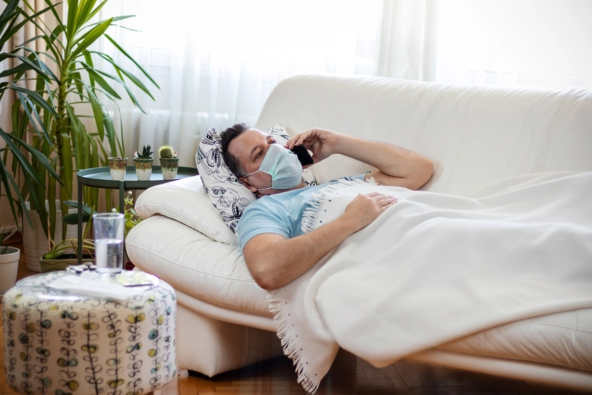 man on couch with covid