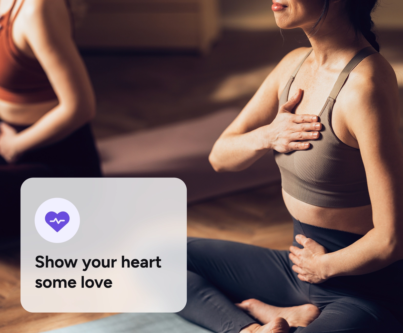 A woman doing yoga and checking her heart rate