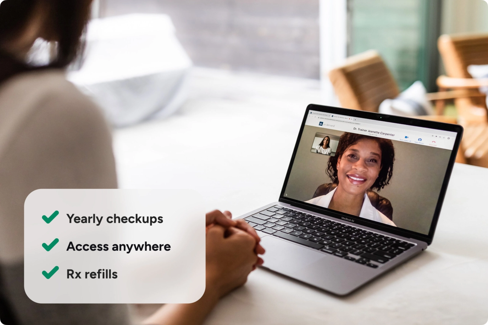 A woman on a video call with her doctor