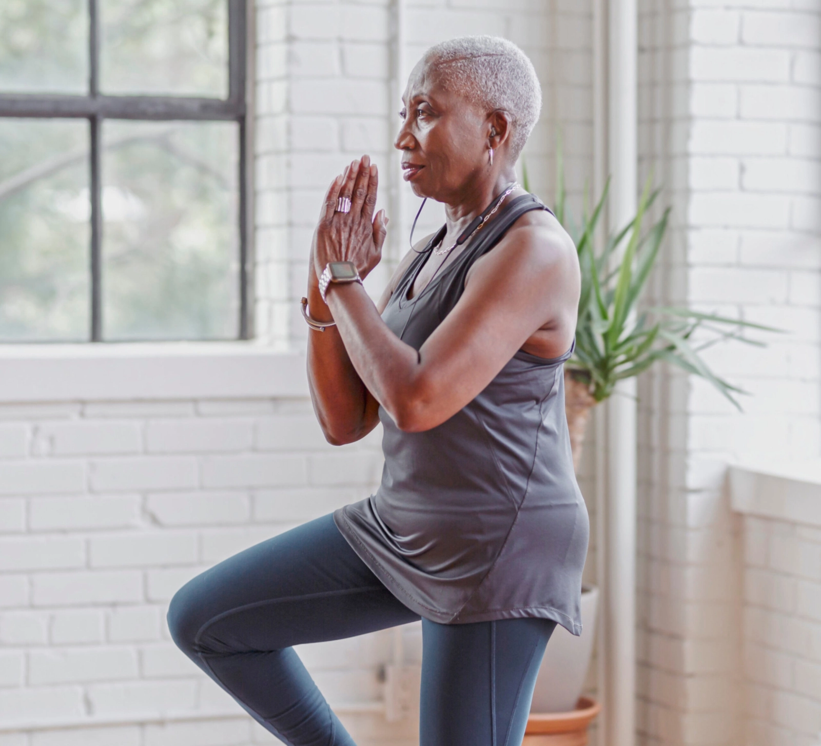 An older woman doing yoga.